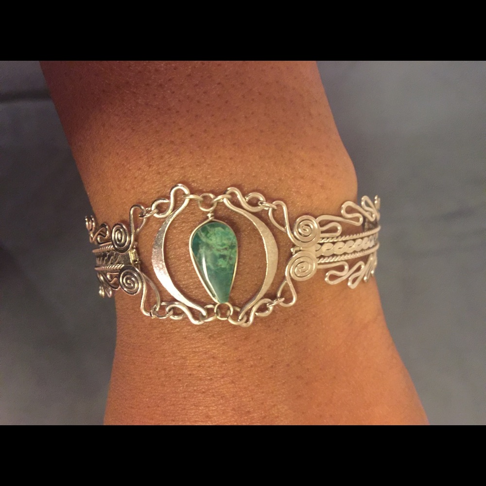 Silver bracelet with green tear drop stone